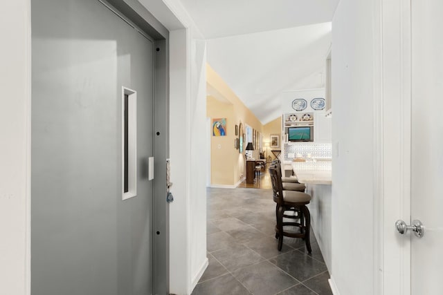 33 Pen Key Dr, Islamorada, FL 33036 - hall featuring lofted ceiling and dark tile patterned floors