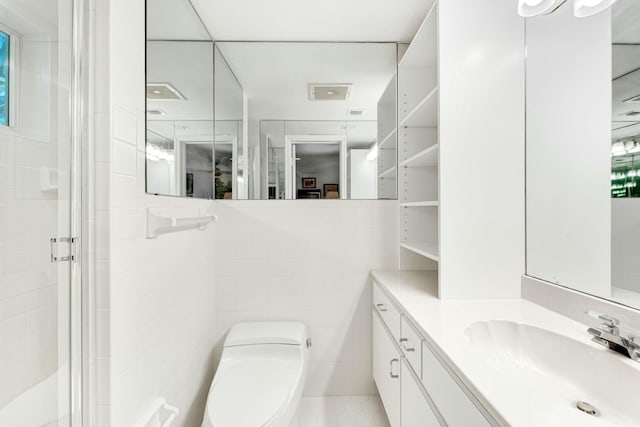 33 Pen Key Dr, Islamorada, FL 33036 - bathroom with tile walls, vanity, a shower with shower door, and toilet