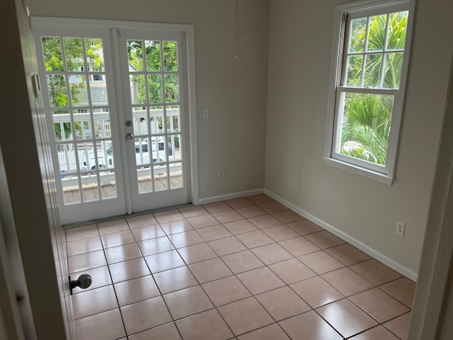 8 Kestral Way, Key West, FL 33040 - empty room with healthy amount of natural light and light tile patterned flooring