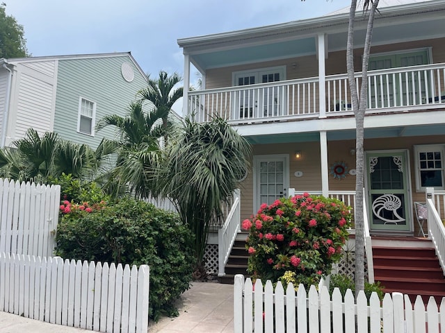 8 Kestral Way, Key West, FL 33040 - view of property with a balcony, covered porch, and stairway