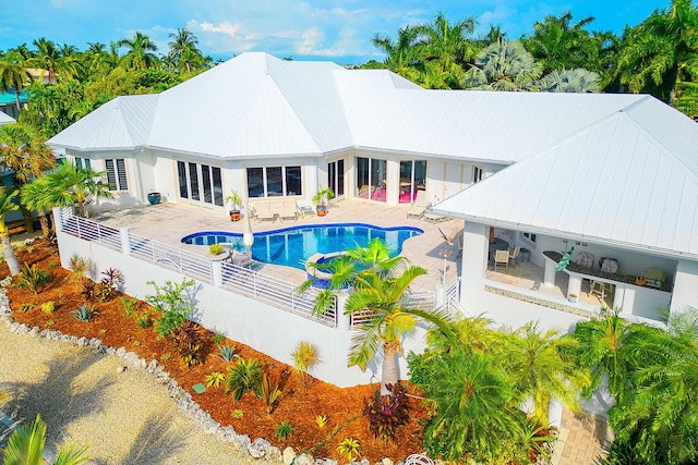 view of pool with area for grilling and a patio area