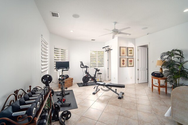 workout room with light tile patterned flooring and ceiling fan