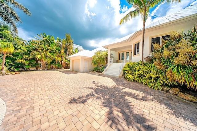 view of front of property with a garage and french doors