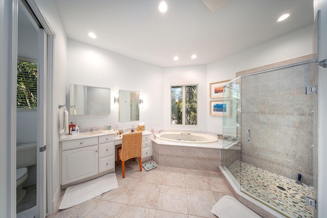 bathroom with tile patterned floors, a healthy amount of sunlight, independent shower and bath, and vanity