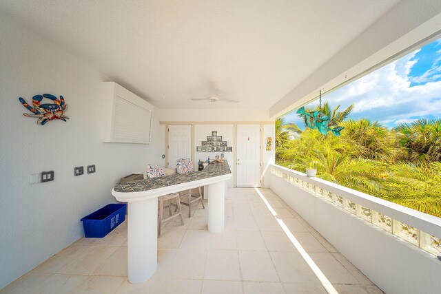 view of patio / terrace featuring ceiling fan and a balcony