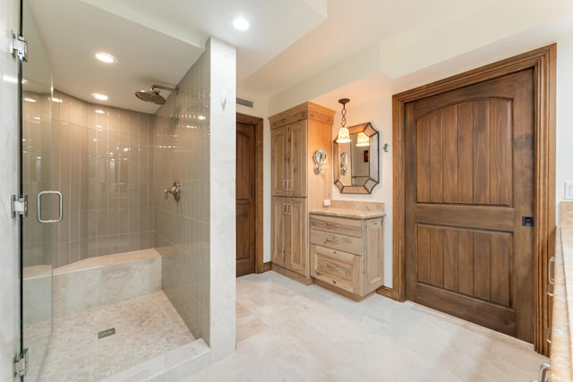 bathroom featuring walk in shower and vanity