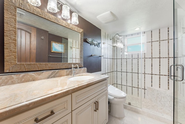 bathroom with vanity, tile patterned flooring, a shower with shower door, and toilet