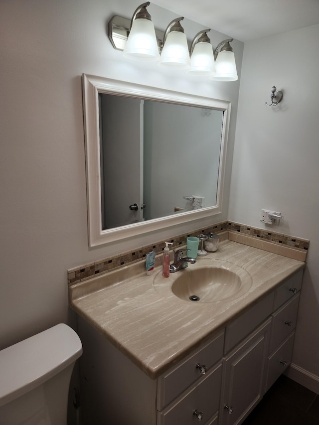 bathroom featuring vanity and toilet