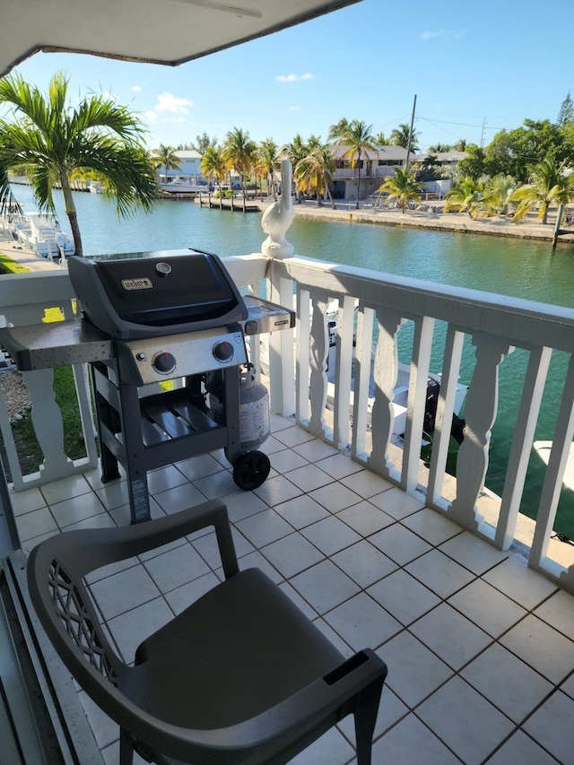 balcony featuring a grill and a water view