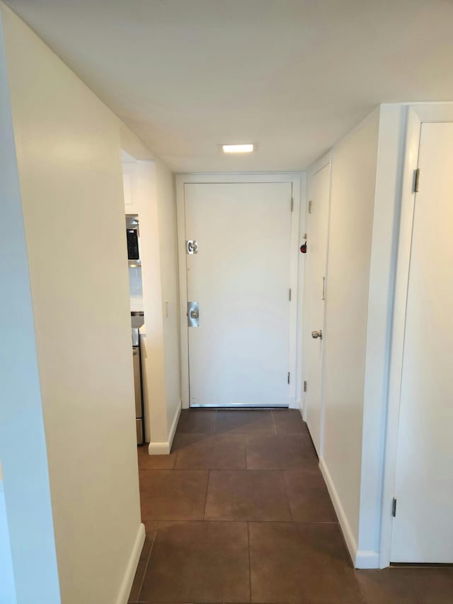 corridor with dark tile patterned flooring