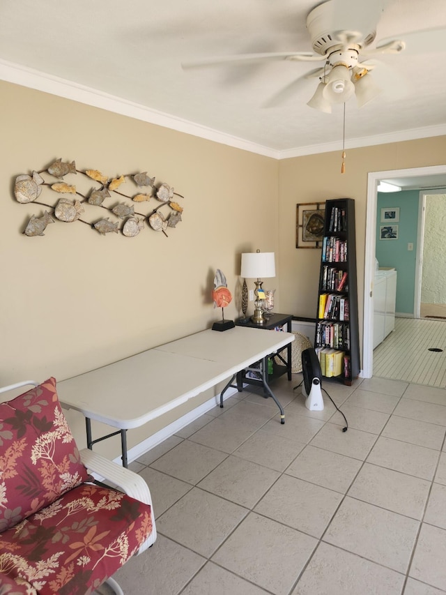 interior space with light tile patterned flooring, ornamental molding, ceiling fan, and washer and dryer