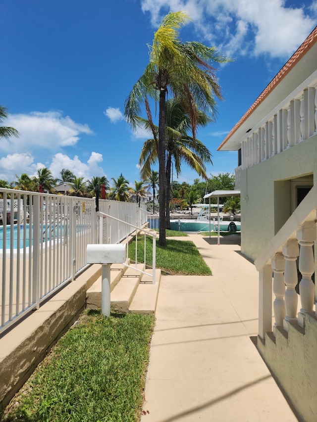 exterior space featuring fence and a community pool