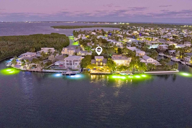 aerial view at dusk with a water view