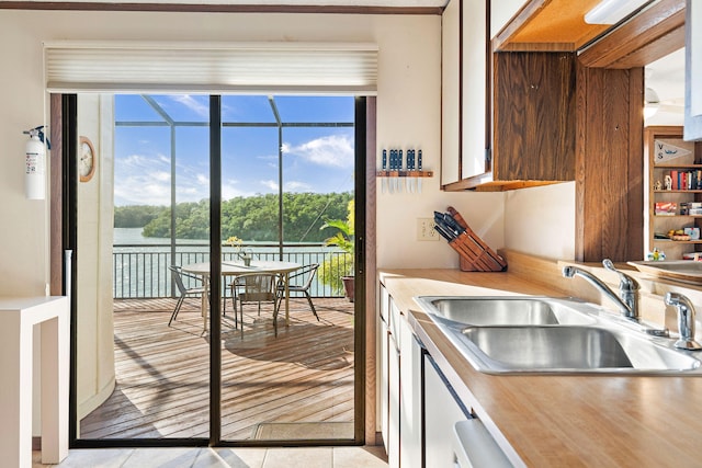 kitchen with a water view and sink