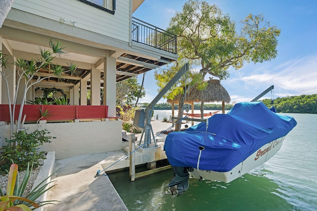 dock area featuring a water view and a balcony