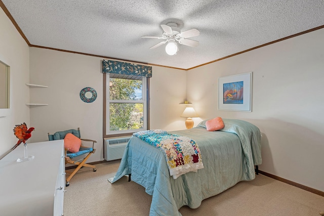 carpeted bedroom with ceiling fan, a wall unit AC, ornamental molding, and a textured ceiling