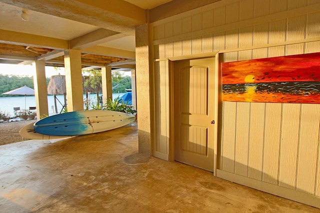 exterior space featuring concrete flooring and a water view