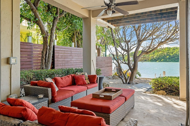 view of patio / terrace with an outdoor living space, a water view, and ceiling fan