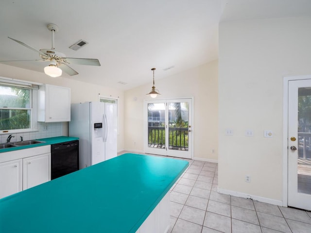 kitchen with sink, black dishwasher, white cabinets, white refrigerator with ice dispenser, and light tile patterned floors