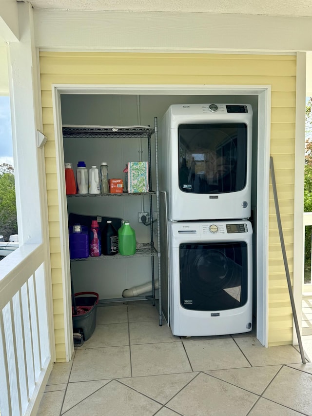 27821 Leeward S Rd, Little Torch, FL 33042 - laundry area featuring stacked washer and clothes dryer, tile patterned floors, and healthy amount of natural light