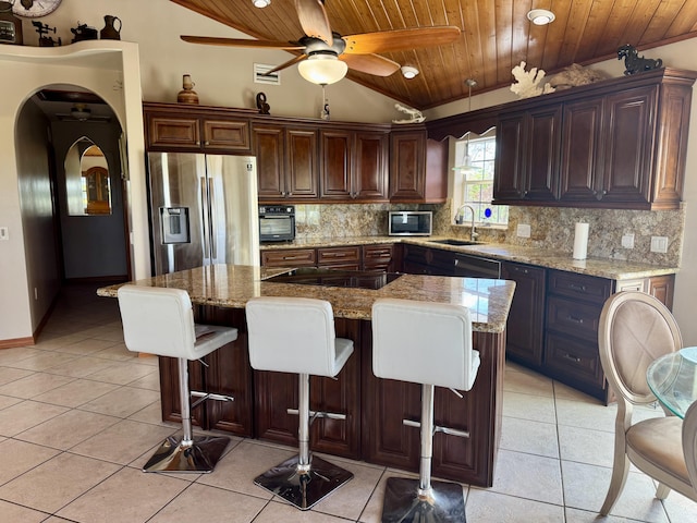 27821 Leeward S Rd, Little Torch, FL 33042 - kitchen with appliances with stainless steel finishes, wood ceiling, lofted ceiling, light tile patterned floors, and backsplash