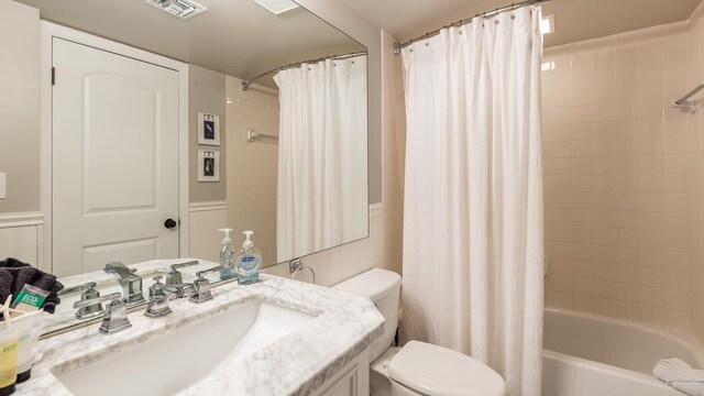 full bathroom featuring vanity, toilet, and shower / bath combo with shower curtain