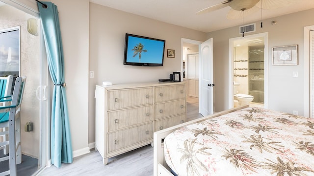 bedroom featuring ceiling fan, light wood-type flooring, and ensuite bath