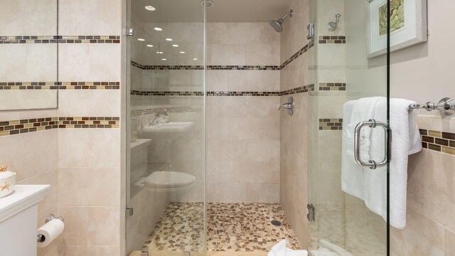 bathroom with a shower with door