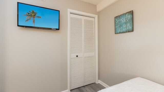 bedroom featuring hardwood / wood-style flooring and a closet