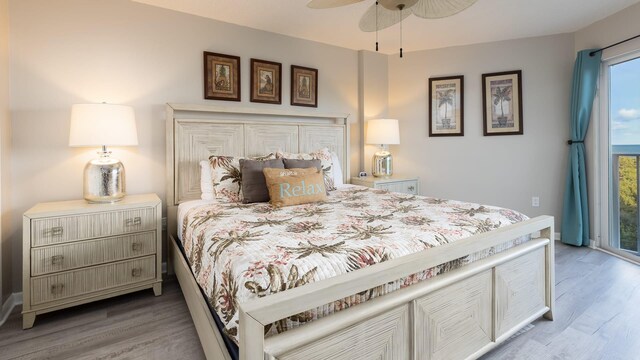 bedroom featuring hardwood / wood-style floors, access to exterior, and ceiling fan