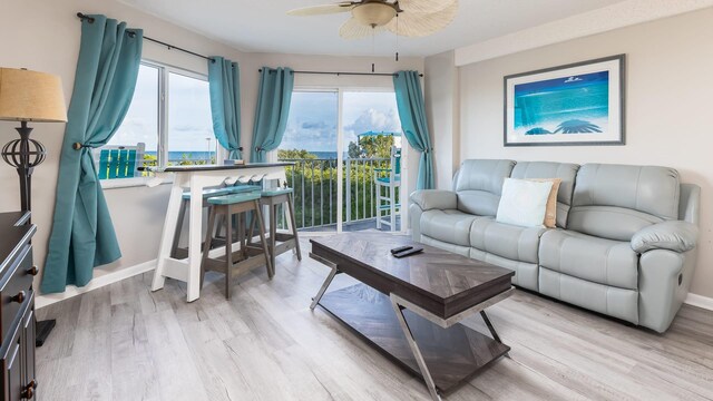 living room featuring ceiling fan and light hardwood / wood-style flooring