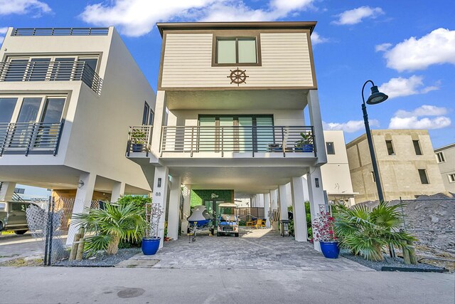 exterior space featuring a carport and a balcony