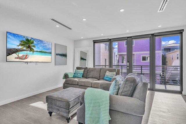 living room with french doors and light hardwood / wood-style flooring