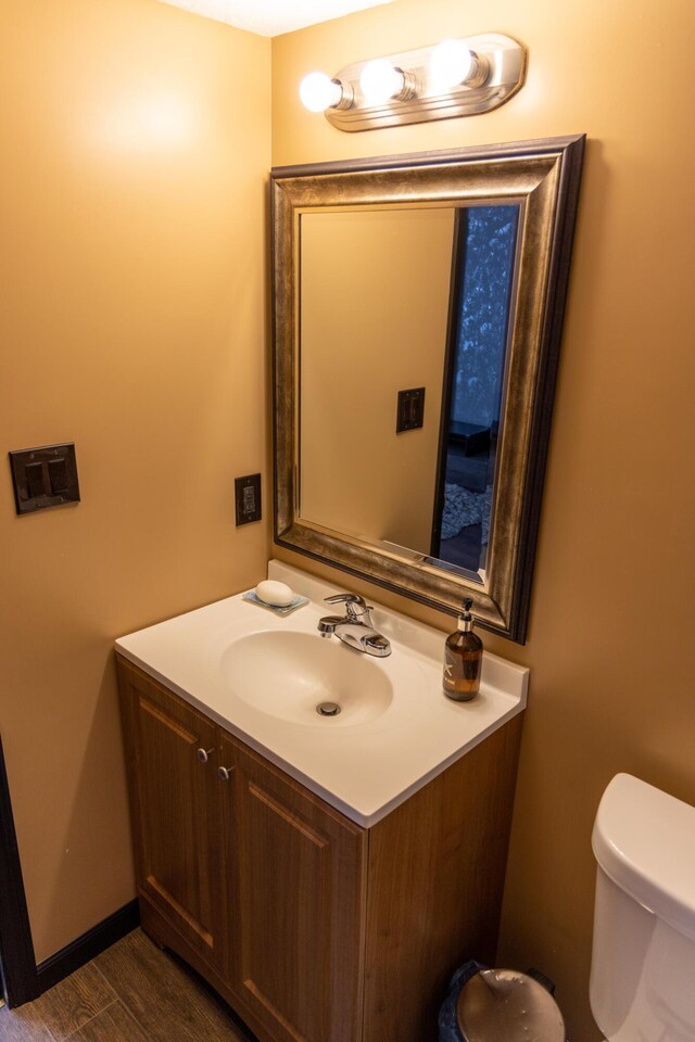 3355 Flagler Ave, Key West, FL 33040 - half bathroom with toilet, vanity, and wood finished floors