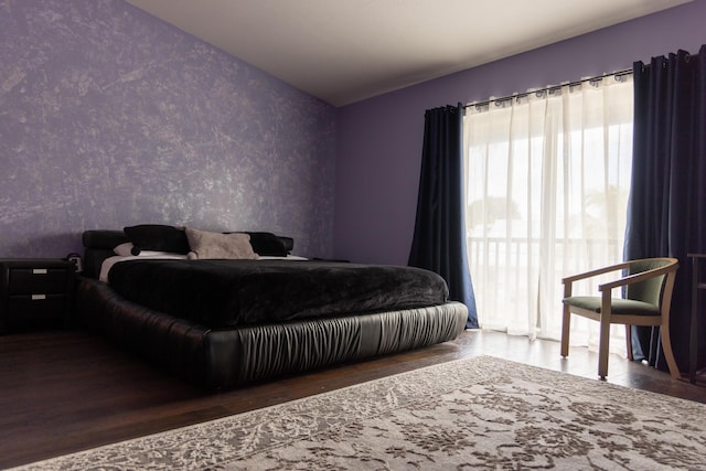 3355 Flagler Ave, Key West, FL 33040 - bedroom featuring wallpapered walls, wood finished floors, and an accent wall