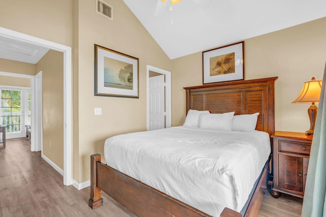 bedroom featuring vaulted ceiling, light hardwood / wood-style floors, and ceiling fan