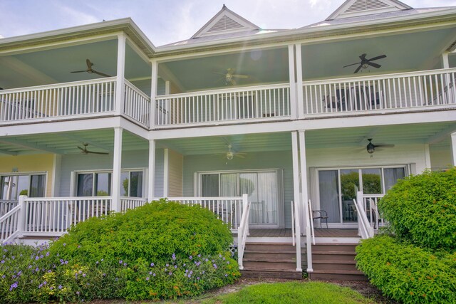 rear view of house featuring ceiling fan, a balcony, and covered porch