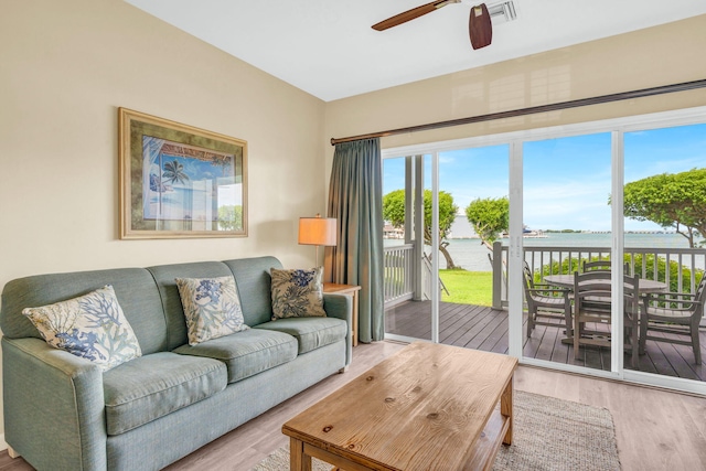 living room featuring a water view, ceiling fan, and wood-type flooring