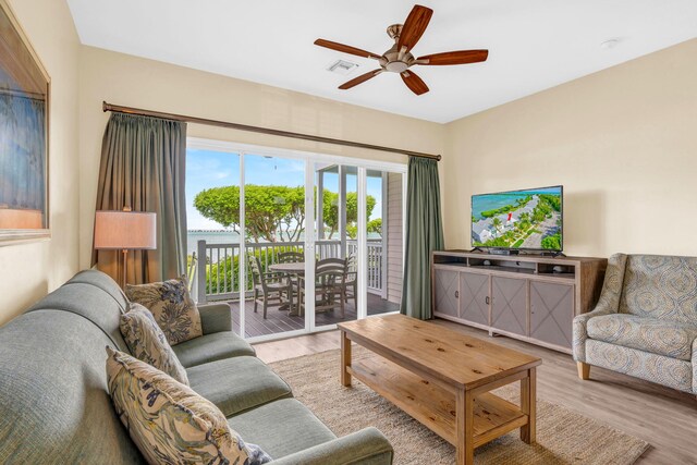 living room featuring ceiling fan and light wood-type flooring