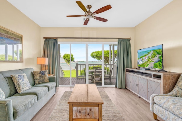 living room with ceiling fan, plenty of natural light, and light hardwood / wood-style floors