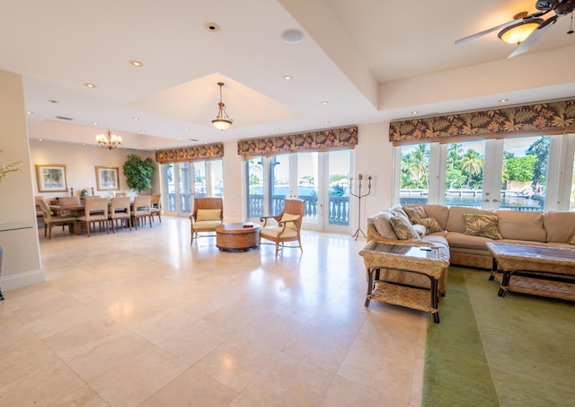 33 Cypress Ave, Key Haven, FL 33040 - living room with a raised ceiling, recessed lighting, french doors, a chandelier, and light tile patterned floors