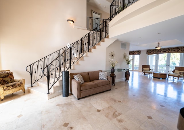 33 Cypress Ave, Key Haven, FL 33040 - tiled living room with stairway, a high ceiling, and french doors