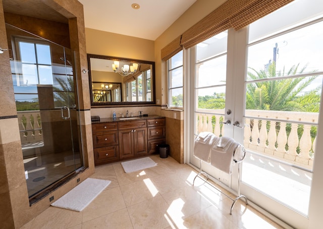 33 Cypress Ave, Key Haven, FL 33040 - bathroom with vanity, a shower stall, a chandelier, and tile patterned floors