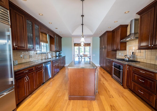 33 Cypress Ave, Key Haven, FL 33040 - kitchen featuring wall chimney exhaust hood, stainless steel appliances, a center island, light wood finished floors, and recessed lighting