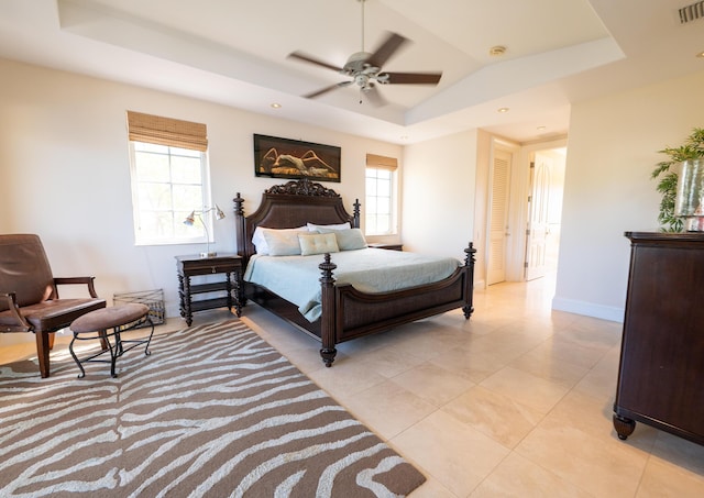33 Cypress Ave, Key Haven, FL 33040 - bedroom featuring a tray ceiling, multiple windows, and light tile patterned floors