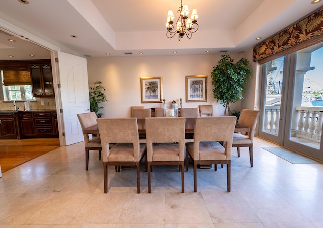33 Cypress Ave, Key Haven, FL 33040 - dining area featuring a chandelier, a raised ceiling, light tile patterned flooring, and recessed lighting