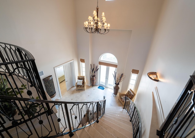 33 Cypress Ave, Key Haven, FL 33040 - stairs with a towering ceiling, a chandelier, and french doors