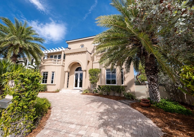 33 Cypress Ave, Key Haven, FL 33040 - mediterranean / spanish-style home with french doors, a balcony, stucco siding, and driveway