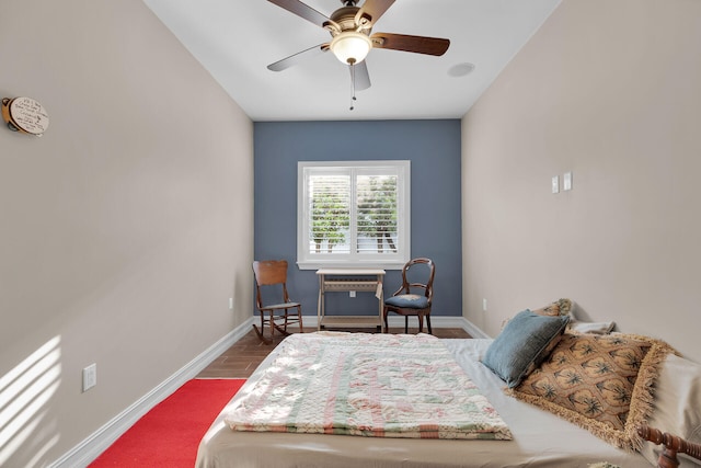 bedroom with a ceiling fan, baseboards, and wood finished floors