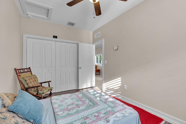 bedroom with visible vents, baseboards, attic access, and a closet